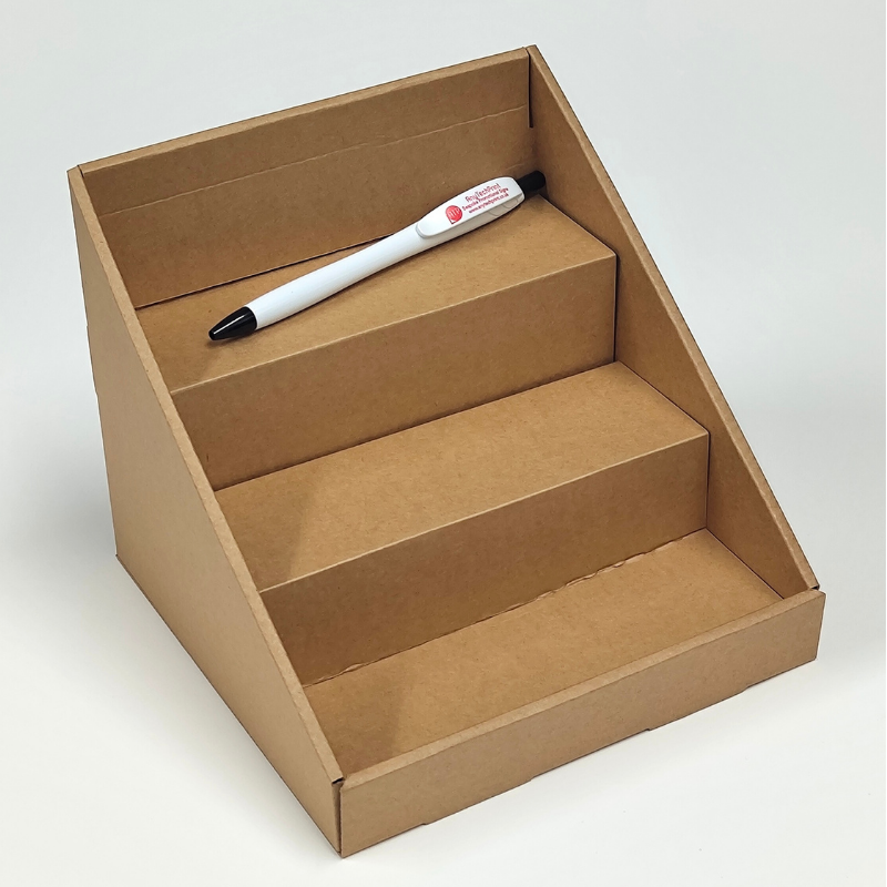 Cardboard display stand with a pen on a white background